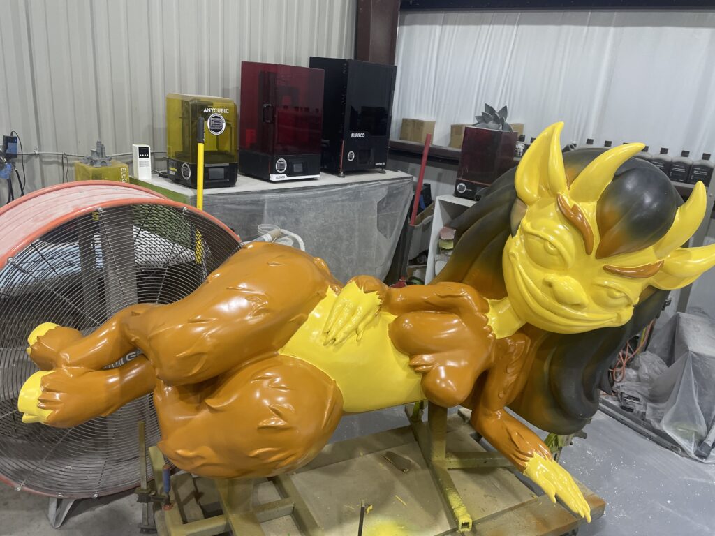 Big Mouth character sculpture in studio with drying automotive paint