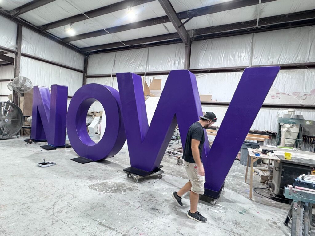 Huge foam letters by Smash Design spelling out "NOW" in our Texas studio